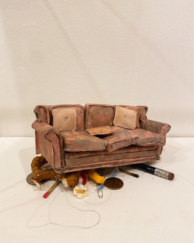 art exhibit by lydia ricci of couch atop pencil and pretzel scraps