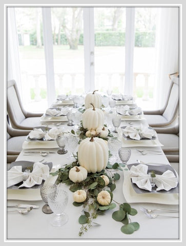 Table with white linens and plates