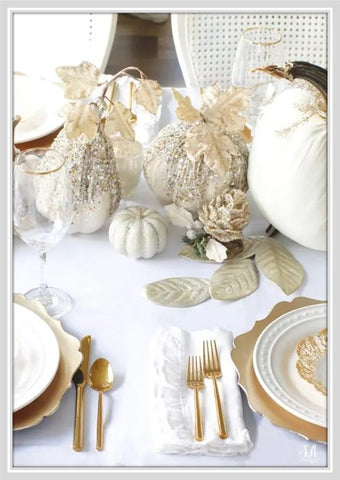 Table with gold chargers and beaded pumpkins