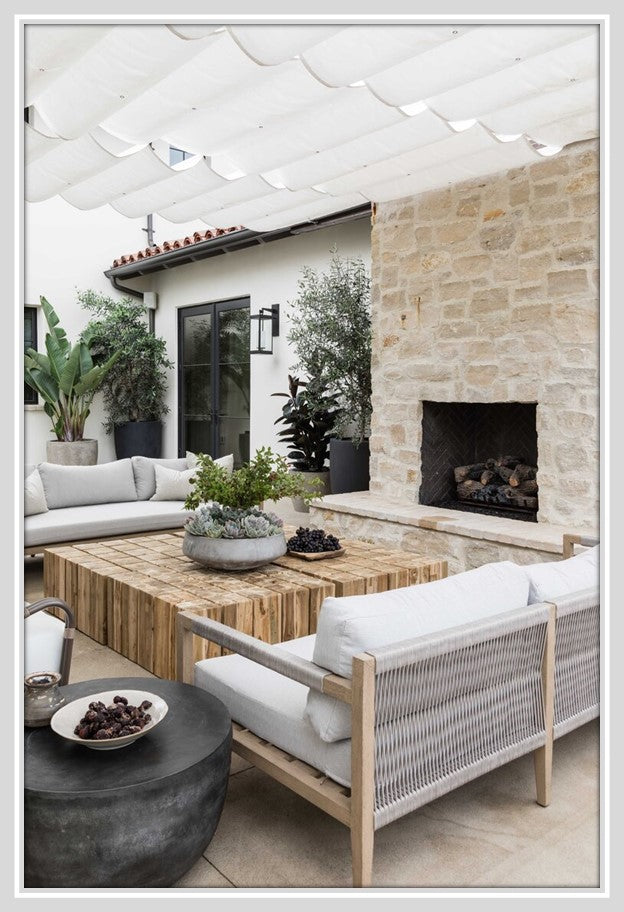 An outdoor fireplace area with roof and seating.