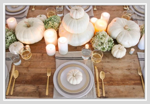 Table set with white pumpkins and flowers