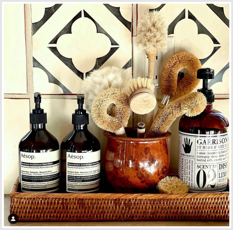 A set of bathroom accessories, soap dispensers on a rattan tray