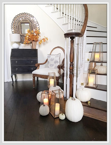 Large lanterns and scattered white pumpkins on staircase