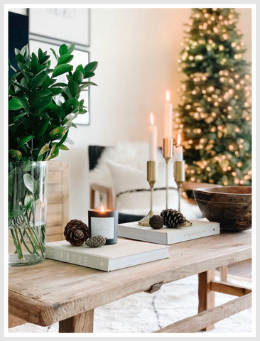 A room with various holiday decorations including a wreath, ornaments, and candles.