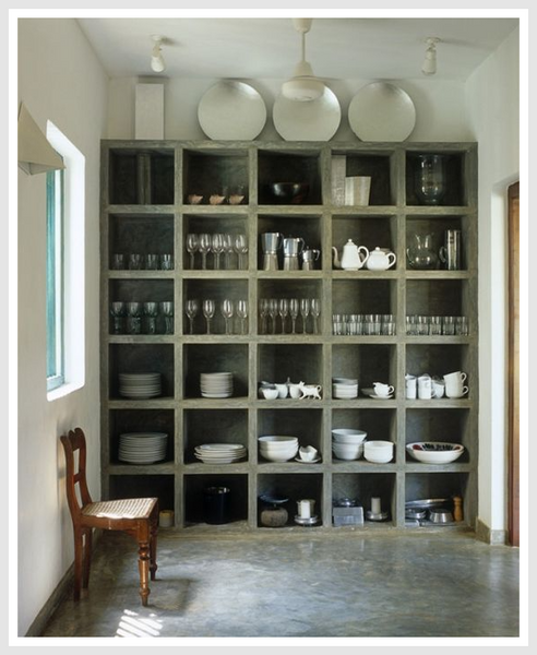 A large shelf containing white plates, dishes, tableware