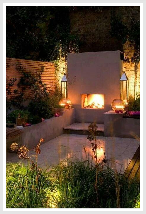 Lit outdoor fireplace in the late evening.