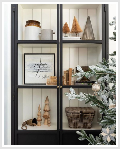 Home decor and accessories displayed in a cabinet with transparent doors