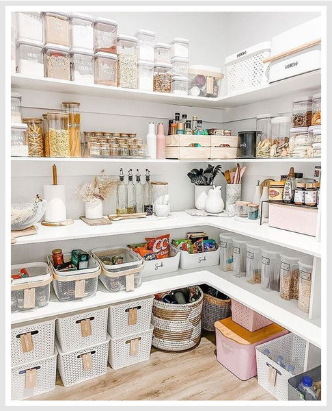White pantry shelves filled with various food items and kitchenware.