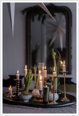 Decorative candles on a dark serving tray.