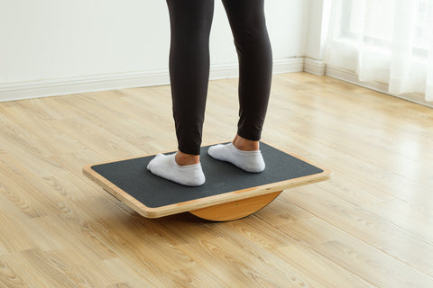 a woman standing on a balance board