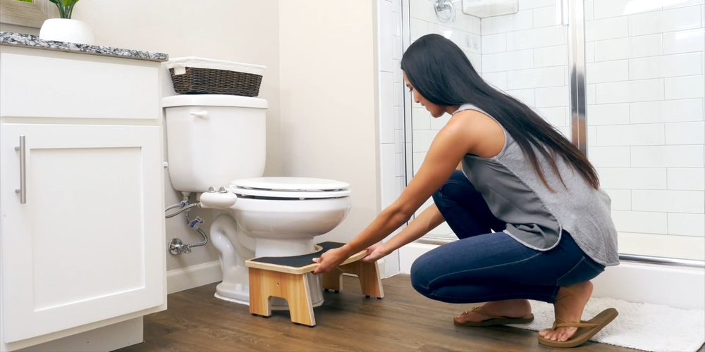A woman putting toilet stool