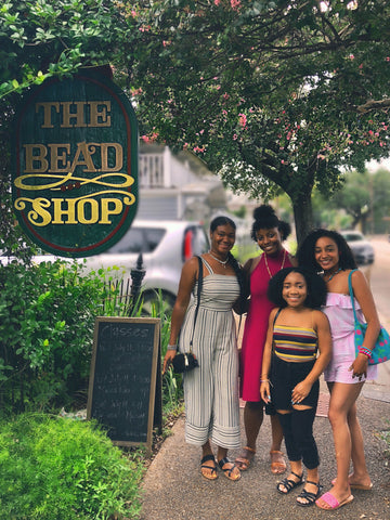 Women stand outside of The Bead Shop after making jewelry together 