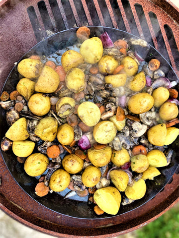 frying vegetables on a firepit