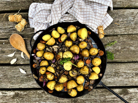 New potato and vegetable fry up on a wood fire