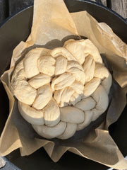 plaited bread dough ready for outdoor cooking on firepit