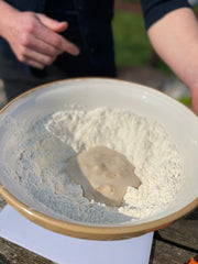 Mixing wet and dry ingredients together to create bread dough