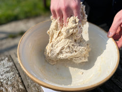kneading dough to form a solid ball