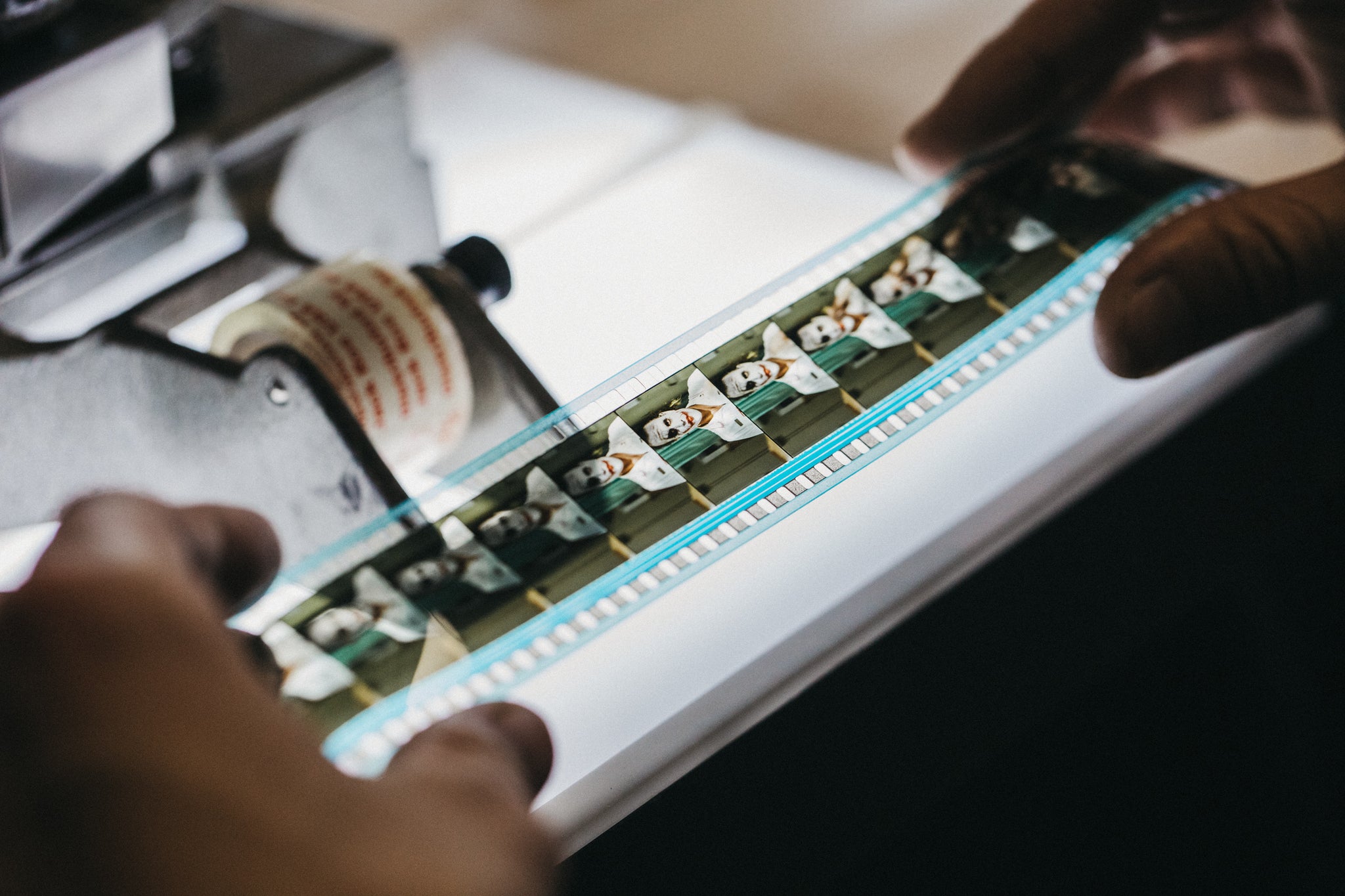 Hands inspect 35mm film up close