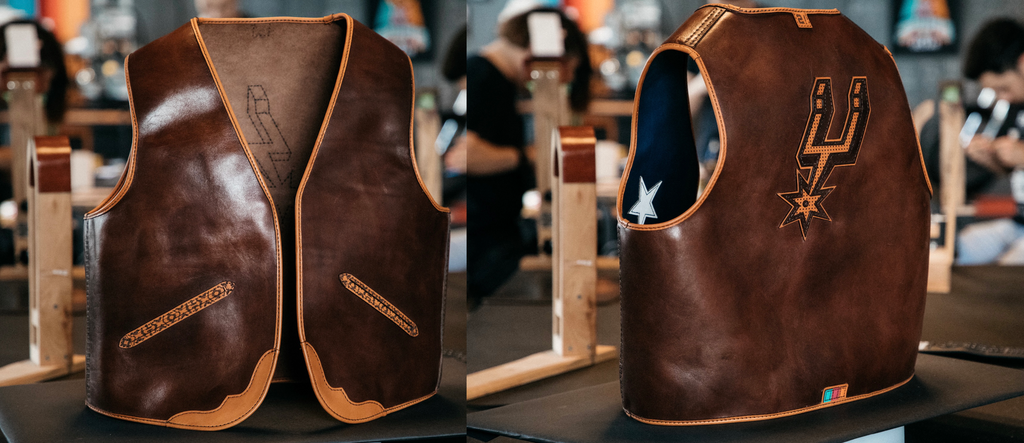 A stiff completed leather vest made by Bexar Goods is propped up in the middle of the workshop majestically.