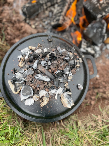 dutch oven and bed of coals cooking on wood