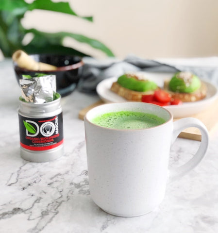 White Cup of Ceremonial Organic Domatcha with Avo Toast in background