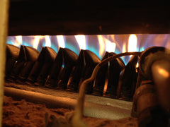 Gas burners underneath the roasting drum