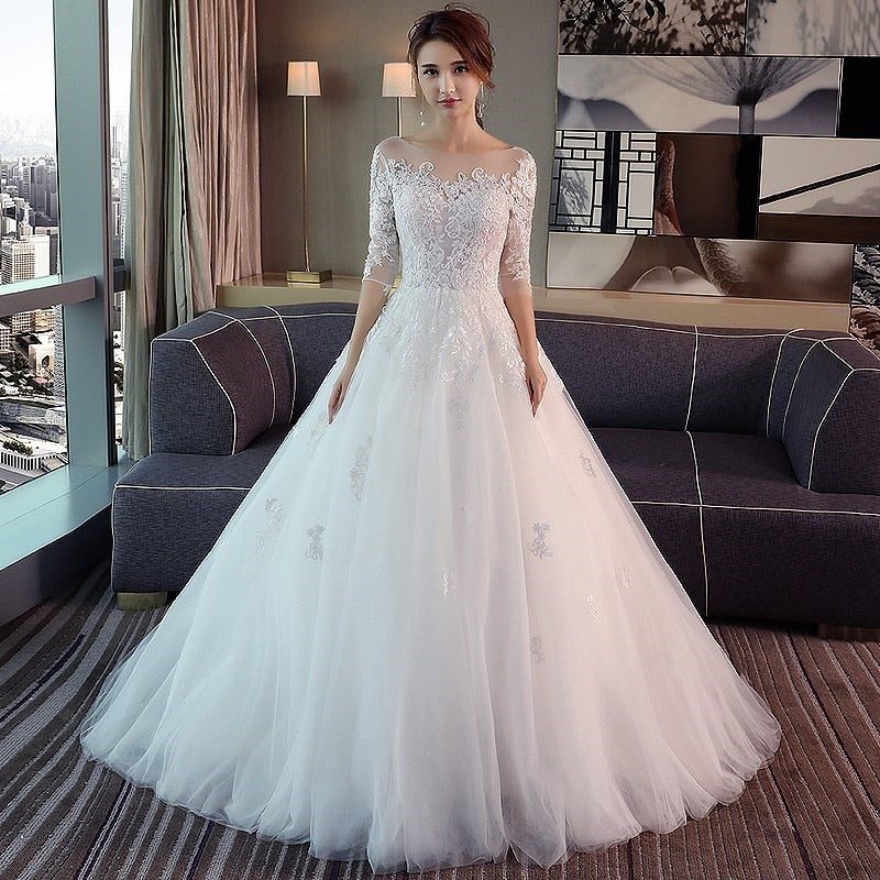 Wedding dress with illusion bodice and sleeves