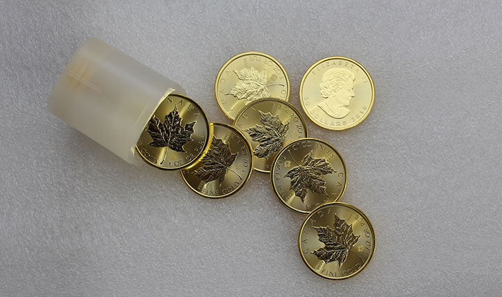 Canadian bullion coins spilling out of a container