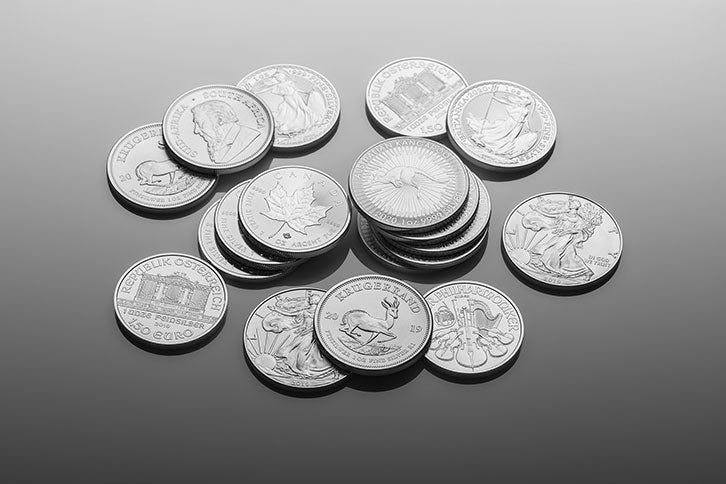 Silver coins scattered in a pile