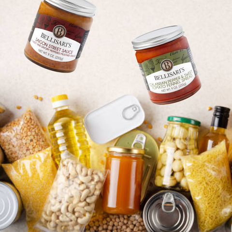 A pile of pantry essentials such as pasta, oil, rice, and beans with Bellisari's sauces and spreads.