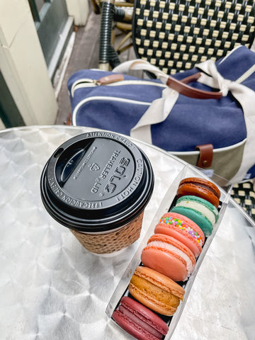 Coffee and macarons with Paperboat duffel on bistro chair