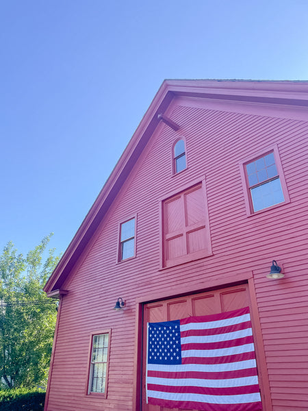 Red barn with flag on it