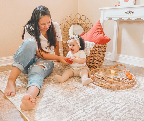 Mom and daughter playing on play mat