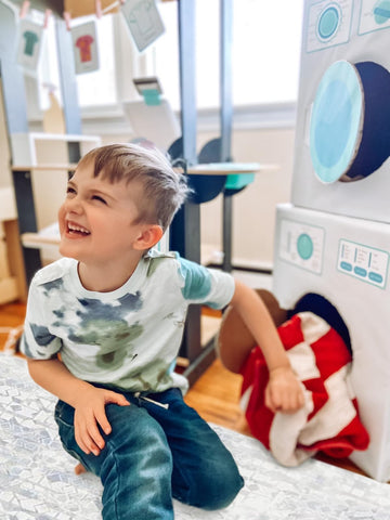 boy playing with pretend play laundromat do it yourself printable