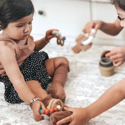 children playing with toys on play mat