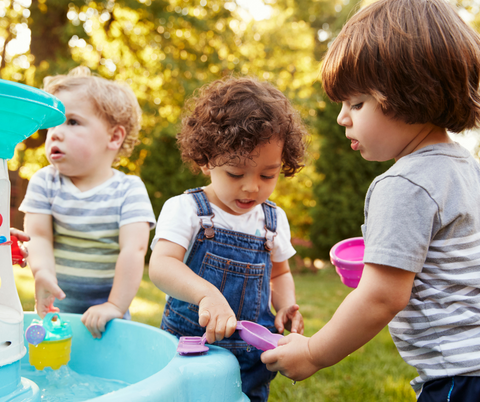 toddlers playing in water table