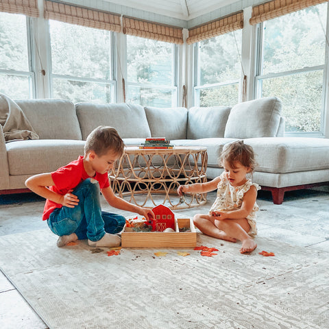 Two children doing sensory play on Famokids Play Mat