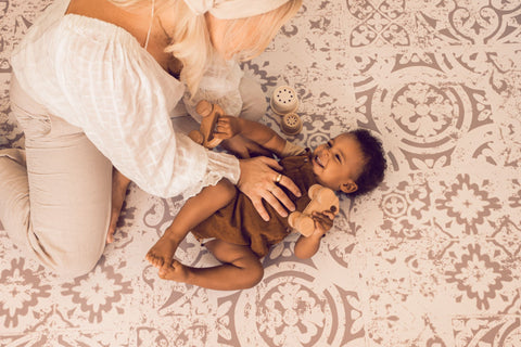 baby and mom on play mat