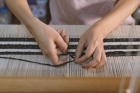 Mariella Motilla weaving on a hand loom