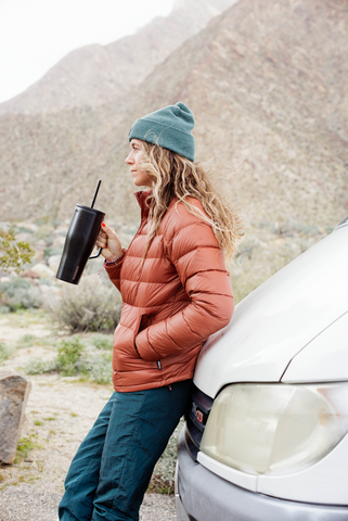 Woman Drinking Corkcicle Insulated Water Bottle with Handle Leaning on Car