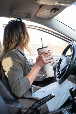 Woman Driving Holding Corkcicle Insulated Tumbler with Handle