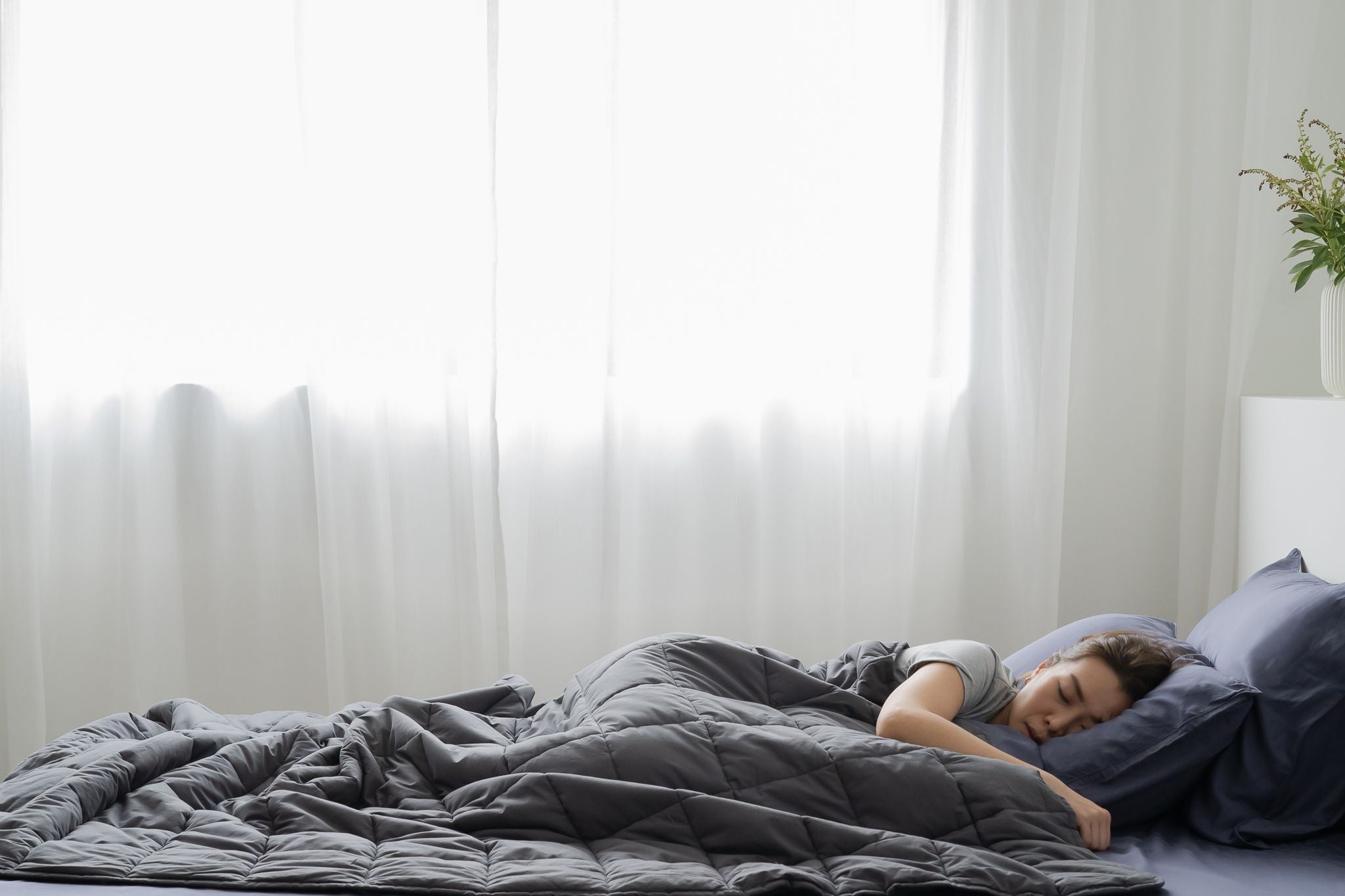 Woman in deep sleep under Weavve's weighted blanket