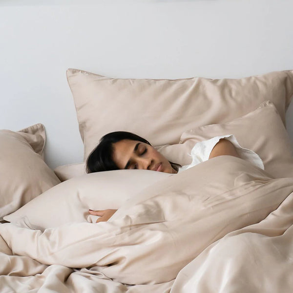 Woman comfortably sleeping on TENCEL bed sheets and pillow case