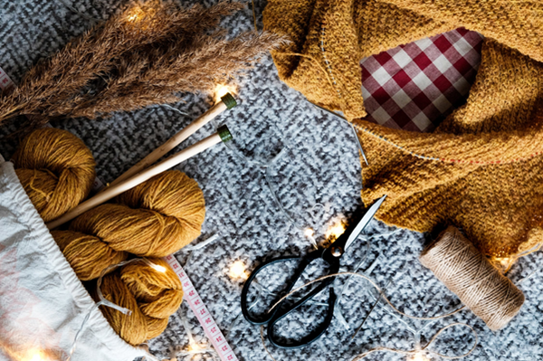 knitted blanket with knitting tools