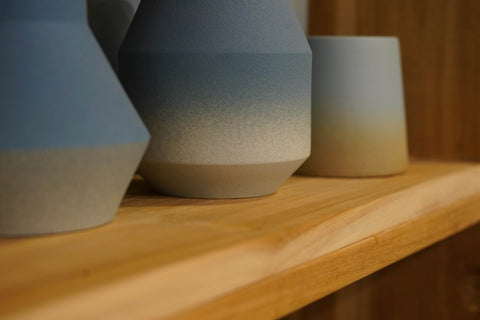 Blue Gradient Pottery Display on Wooden Bookshelves at Gallery 278 by Esco Leasing