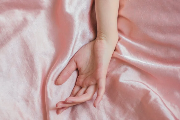 hand on bed sheet