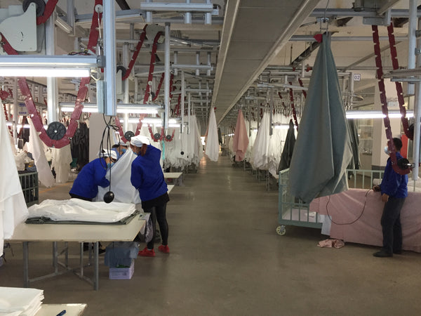 Bed sheet factory with staff making bedding sheets