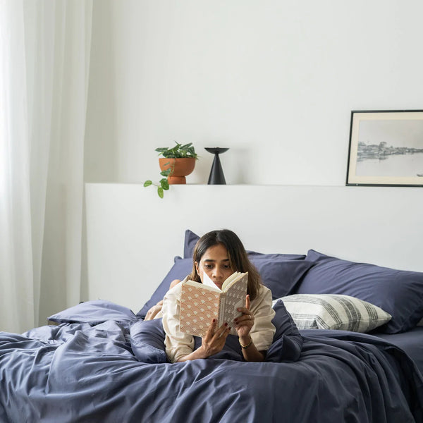 Girl reading a book while lying on Cotton Classic Set