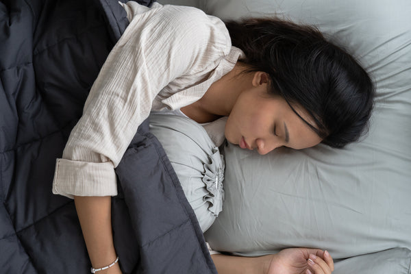 Girl sleeping under weighted blanket