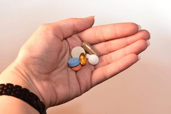 Person holding sleeping pill and capsules